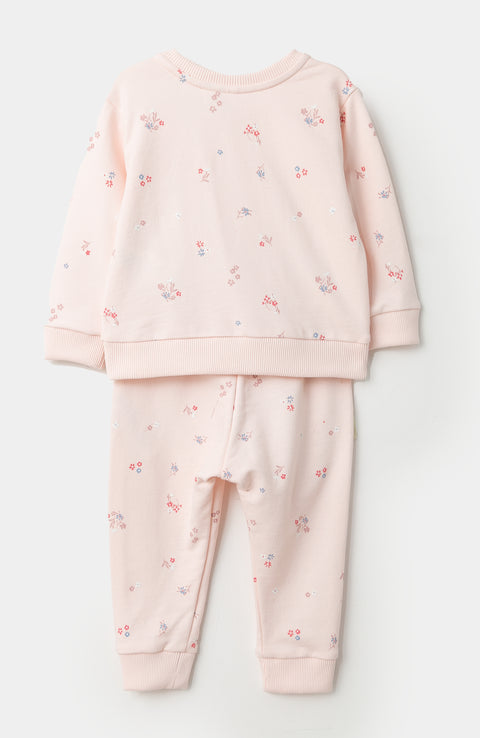 Conjunto de buzo y jogger para recién nacida en burda color rosado claro con estampado de flores